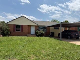 1228 Santa Fe Dr, Clinton, OK 73601 - single story home featuring a front yard, concrete driveway, and an attached carport