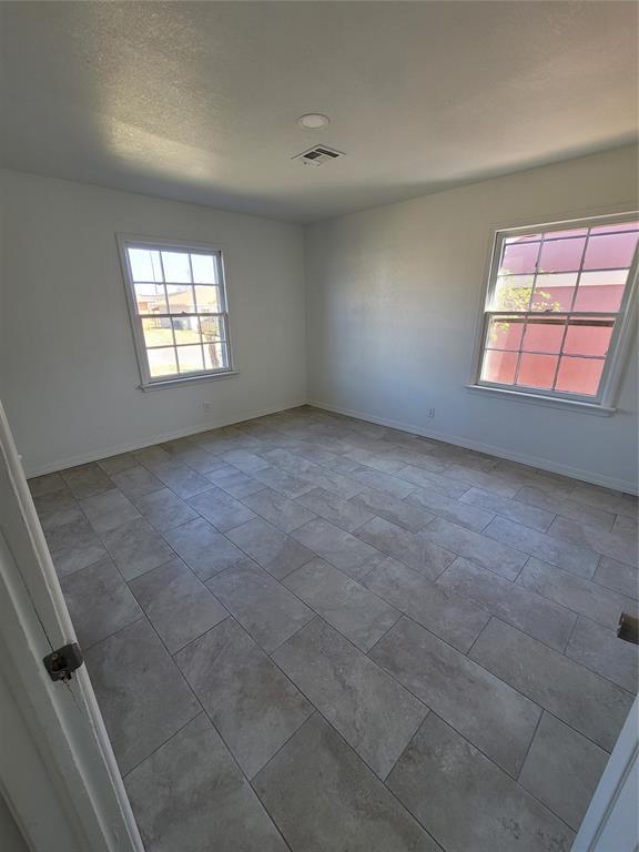 1228 Santa Fe Dr, Clinton, OK 73601 - unfurnished room featuring plenty of natural light and baseboards