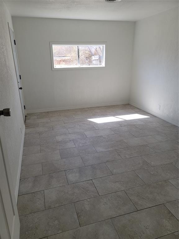 1228 Santa Fe Dr, Clinton, OK 73601 - spare room featuring baseboards