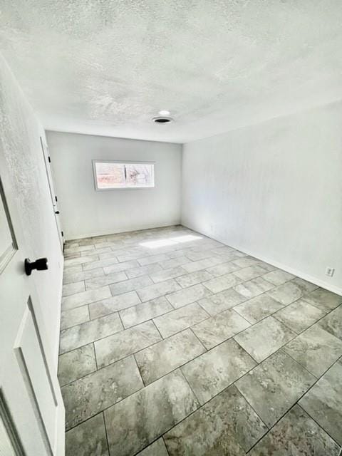 1228 Santa Fe Dr, Clinton, OK 73601 - spare room featuring a textured ceiling