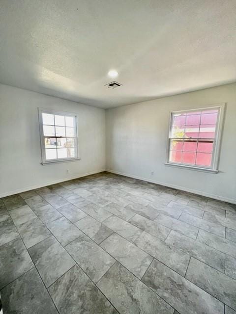 1228 Santa Fe Dr, Clinton, OK 73601 - unfurnished room with healthy amount of natural light and baseboards