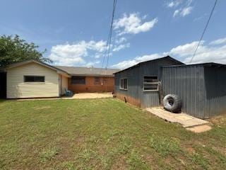 1228 Santa Fe Dr, Clinton, OK 73601 - rear view of house featuring an outbuilding and a yard