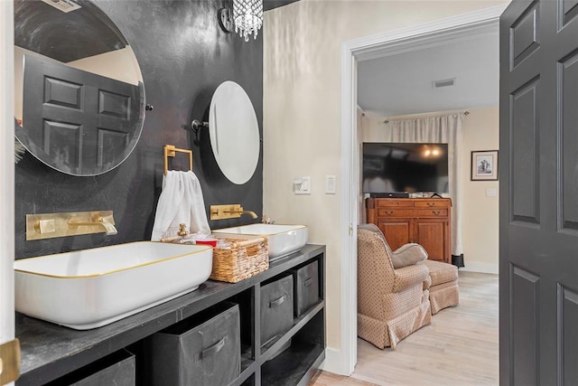 32629 S Airline Rd, Pauls Valley, OK 73075 - ensuite bathroom with wood finished floors and double vanity