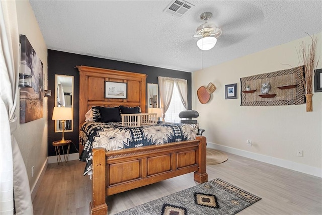 32629 S Airline Rd, Pauls Valley, OK 73075 - bedroom with a textured ceiling, light wood-style flooring, and ceiling fan