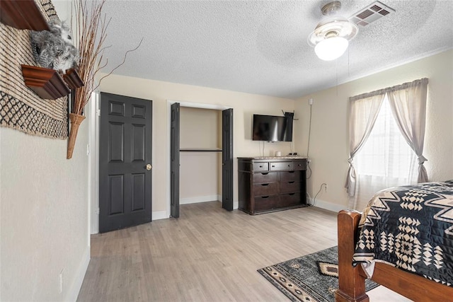 32629 S Airline Rd, Pauls Valley, OK 73075 - bedroom with light wood-type flooring and a textured ceiling