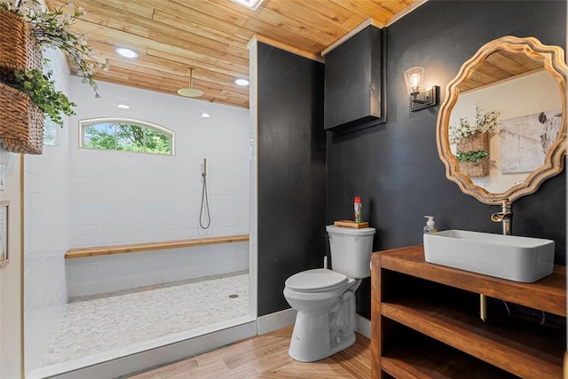 32629 S Airline Rd, Pauls Valley, OK 73075 - bathroom with wood ceiling, wood finished floors, a tile shower, and vanity