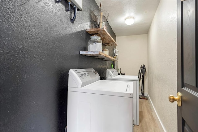 32629 S Airline Rd, Pauls Valley, OK 73075 - laundry room featuring washing machine and clothes dryer, light wood-style floors, and a textured wall