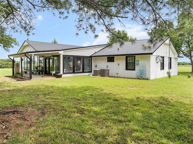 32629 S Airline Rd, Pauls Valley, OK 73075 - rear view of property with a sunroom, a yard, a metal roof, and brick siding