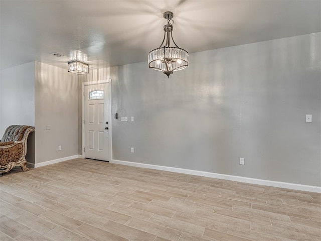4100 S Noma Rd, Oklahoma City, OK 73150 - entrance foyer with light wood-style flooring, baseboards, and a chandelier
