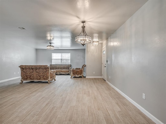 4100 S Noma Rd, Oklahoma City, OK 73150 - sitting room featuring a chandelier, light wood-style floors, and baseboards