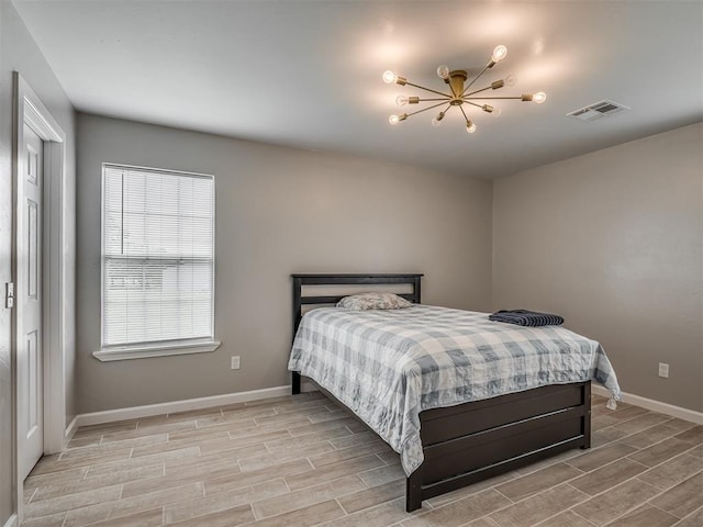 4100 S Noma Rd, Oklahoma City, OK 73150 - bedroom with light wood-type flooring, baseboards, and a chandelier