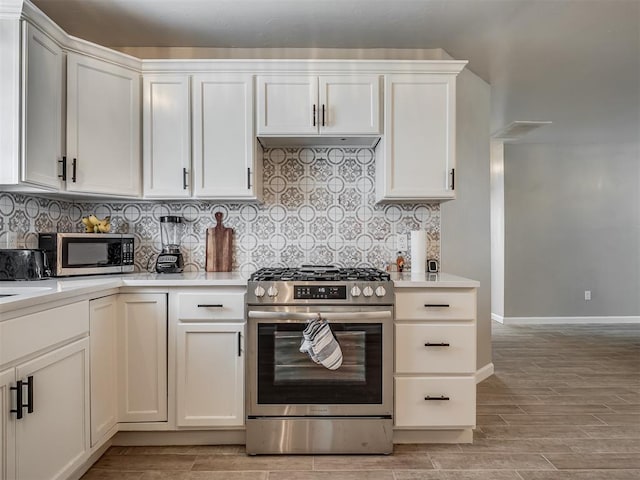 4100 S Noma Rd, Oklahoma City, OK 73150 - kitchen featuring appliances with stainless steel finishes, light countertops, light wood finished floors, and tasteful backsplash
