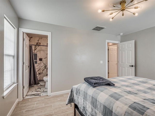 4100 S Noma Rd, Oklahoma City, OK 73150 - bedroom with a chandelier, baseboards, wood tiled floors, and ensuite bath