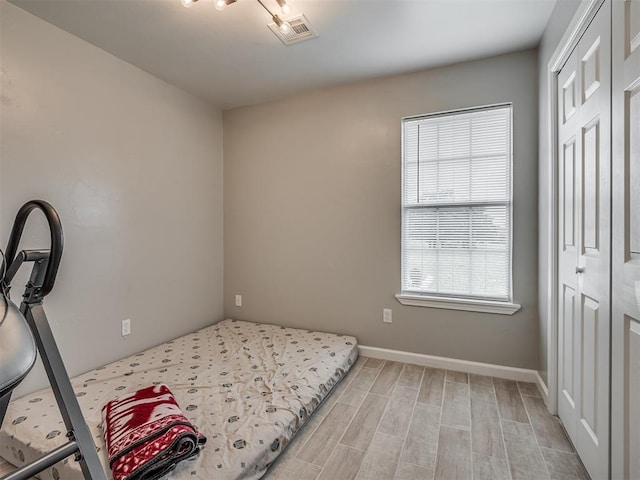 4100 S Noma Rd, Oklahoma City, OK 73150 - bedroom featuring a closet, light wood-style floors, and baseboards