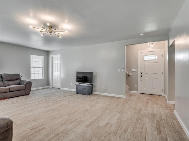 4100 S Noma Rd, Oklahoma City, OK 73150 - living room featuring a chandelier, light wood-style flooring, and baseboards