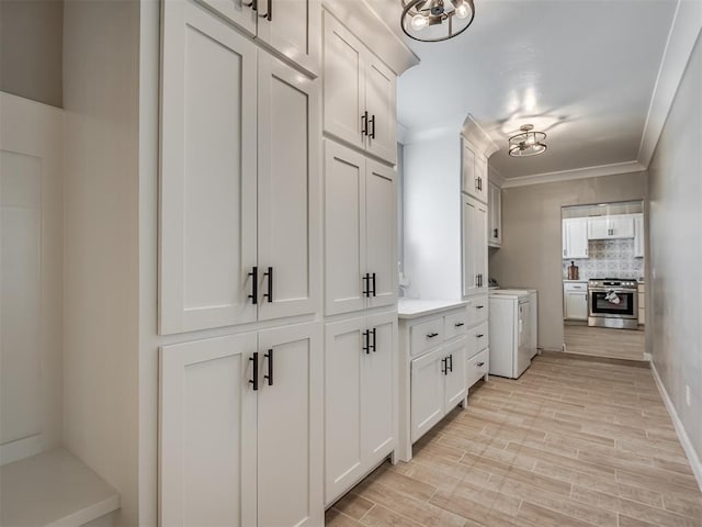 4100 S Noma Rd, Oklahoma City, OK 73150 - hall with independent washer and dryer, light wood-type flooring, and ornamental molding