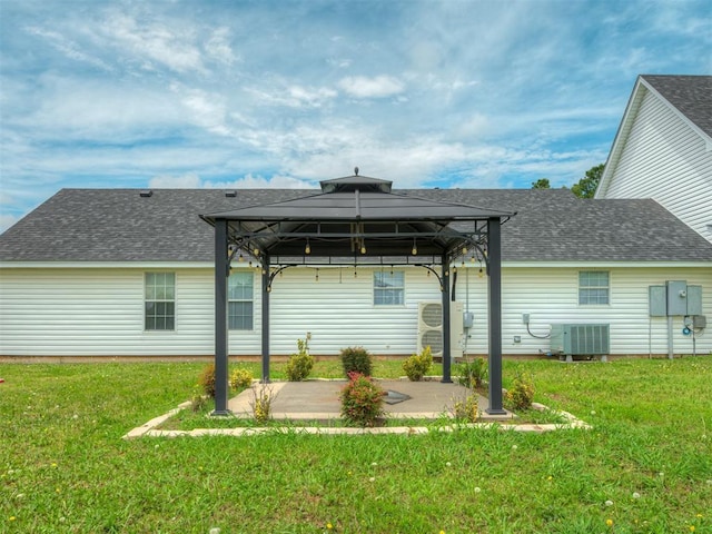 4100 S Noma Rd, Oklahoma City, OK 73150 - back of property featuring a gazebo, a patio area, a shingled roof, a lawn, and central AC