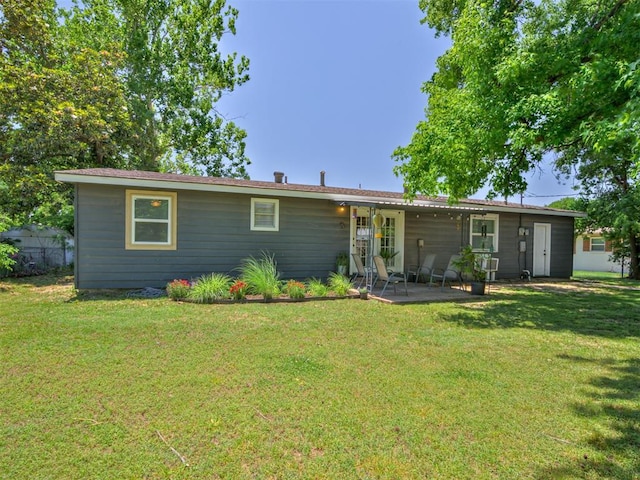 303 W Meek St, Wayne, OK 73095 - rear view of property with a patio area and a lawn