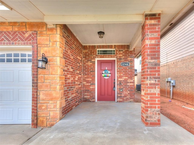 8344 NW 137th St, Oklahoma City, OK 73142 - view of exterior entry with a garage and brick siding