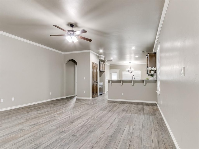 8344 NW 137th St, Oklahoma City, OK 73142 - unfurnished living room featuring light wood-style floors, a ceiling fan, crown molding, and baseboards