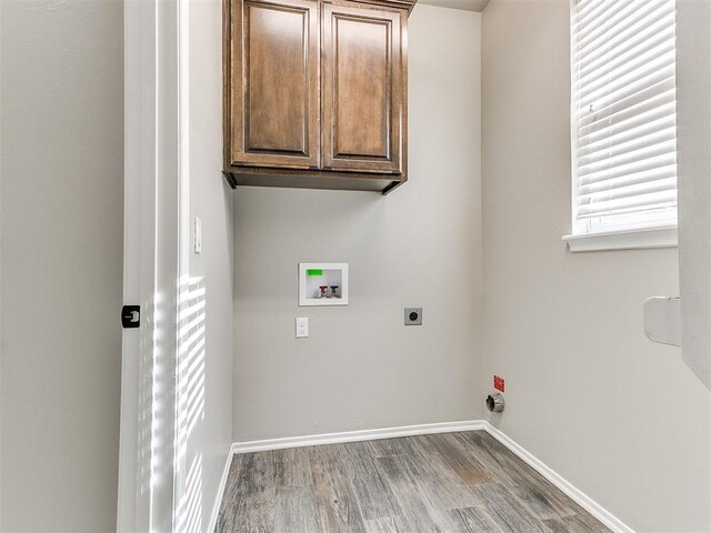 8344 NW 137th St, Oklahoma City, OK 73142 - laundry room with washer hookup, cabinet space, hookup for an electric dryer, wood finished floors, and baseboards