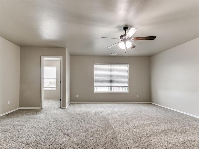 8344 NW 137th St, Oklahoma City, OK 73142 - empty room with plenty of natural light, light carpet, ceiling fan, and baseboards