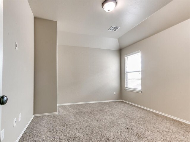 8344 NW 137th St, Oklahoma City, OK 73142 - carpeted spare room featuring baseboards and vaulted ceiling