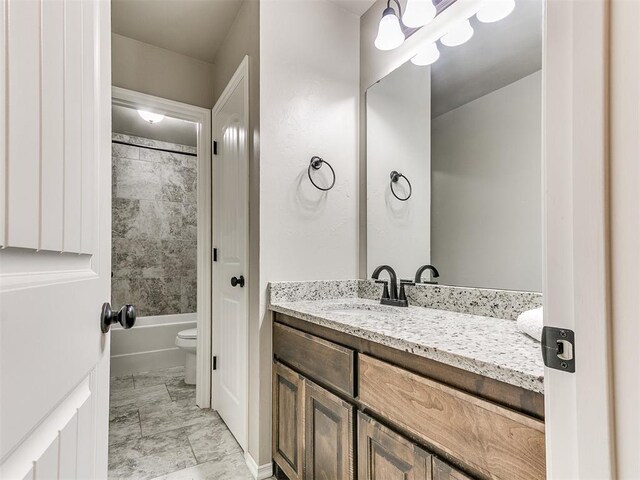 8344 NW 137th St, Oklahoma City, OK 73142 - full bath featuring vanity, marble finish flooring, toilet, and shower / washtub combination