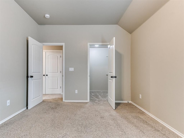 8344 NW 137th St, Oklahoma City, OK 73142 - unfurnished bedroom featuring carpet floors, lofted ceiling, baseboards, and a walk in closet