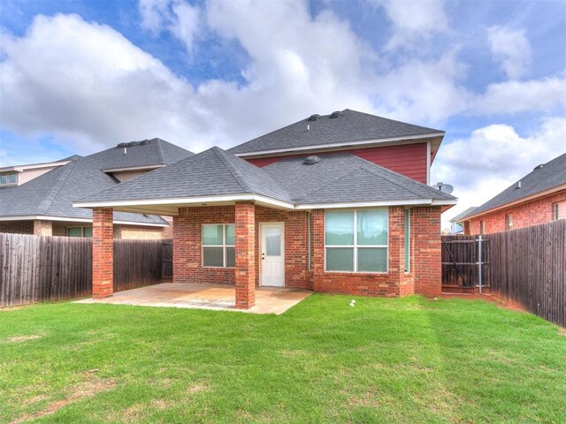 8344 NW 137th St, Oklahoma City, OK 73142 - back of property featuring a patio, brick siding, and roof with shingles