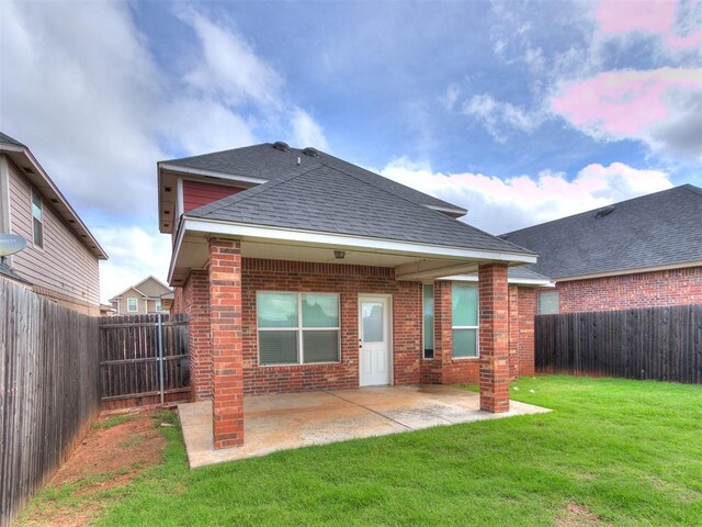 8344 NW 137th St, Oklahoma City, OK 73142 - rear view of house featuring brick siding, a patio, and roof with shingles