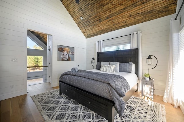72 Green Persimmon Trl, Broken Bow, OK 74728 - bedroom featuring wood ceiling, wooden walls, wood finished floors, and high vaulted ceiling