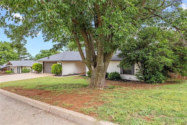 1206 N Kaiser Rd, Weatherford, OK 73096 - view of front of property featuring concrete driveway, a front lawn, a garage, and a shingled roof
