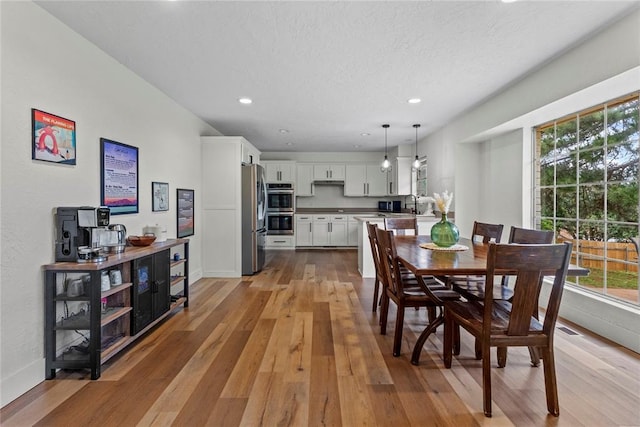 1206 N Kaiser Rd, Weatherford, OK 73096 - dining room featuring light wood-style floors, recessed lighting, and baseboards
