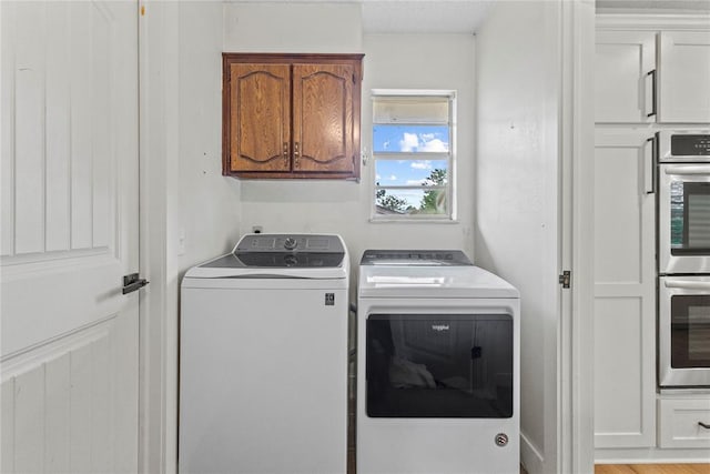 1206 N Kaiser Rd, Weatherford, OK 73096 - laundry room with washing machine and clothes dryer and cabinet space