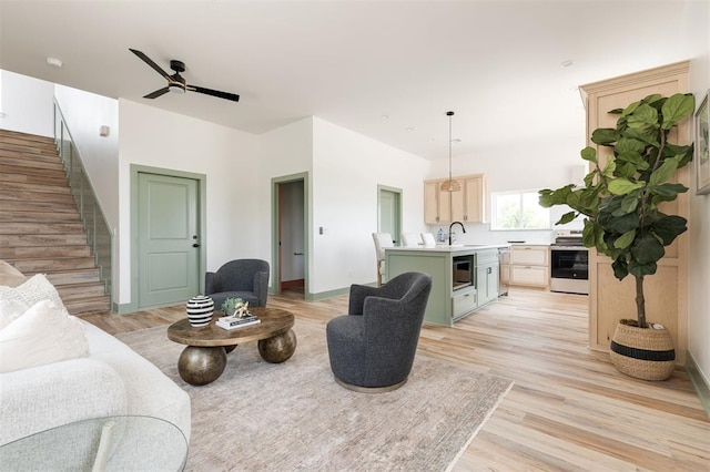 1619 NE 9th St, Oklahoma City, OK 73106 - living room with stairs, light wood-style floors, a ceiling fan, and baseboards