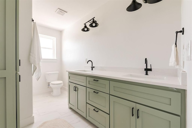 1619 NE 9th St, Oklahoma City, OK 73106 - bathroom with marble finish flooring, toilet, double vanity, and baseboards