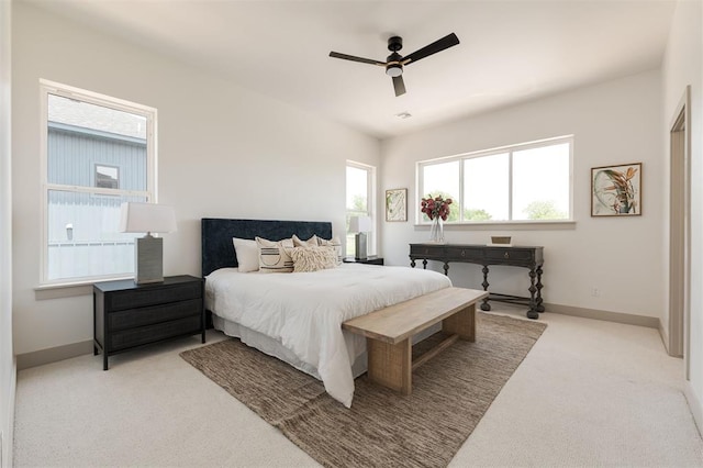 1619 NE 9th St, Oklahoma City, OK 73106 - bedroom with light colored carpet, baseboards, and a ceiling fan