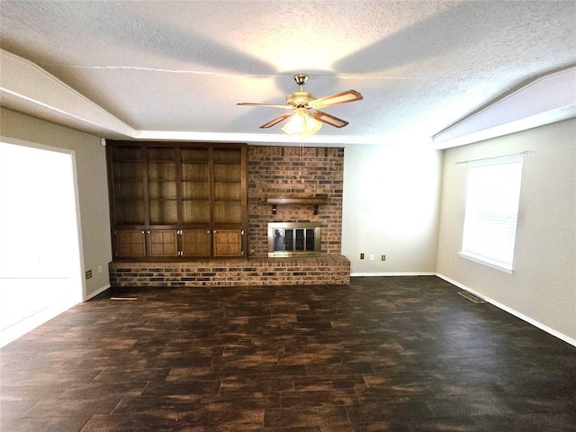 3512 Tiffany Dr, Moore, OK 73160 - unfurnished living room featuring ceiling fan, a textured ceiling, a fireplace, lofted ceiling, and wood finished floors
