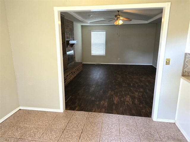 3512 Tiffany Dr, Moore, OK 73160 - unfurnished room with a ceiling fan, a fireplace, and wood finished floors