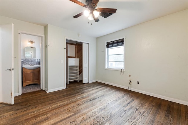 3901 NW 56th Pl, Oklahoma City, OK 73112 - unfurnished bedroom featuring dark wood finished floors, baseboards, a closet, a sink, and a ceiling fan