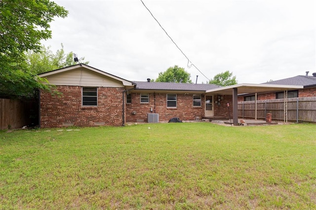 3901 NW 56th Pl, Oklahoma City, OK 73112 - rear view of property with brick siding and central air condition unit