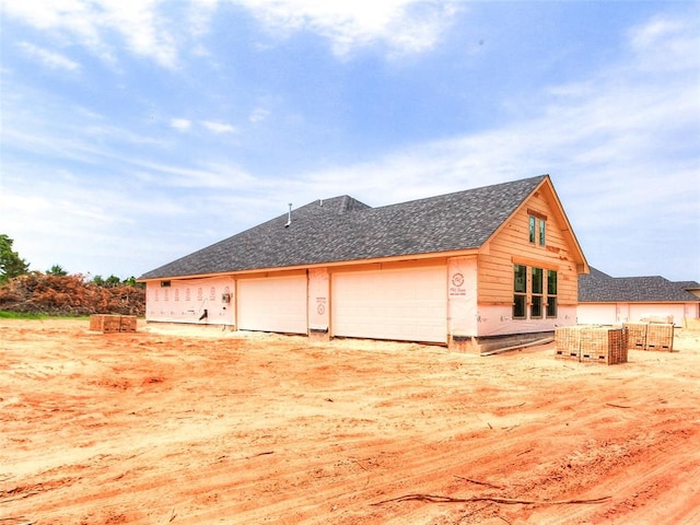 11701 Ward Rd, Edmond, OK 73034 - view of home's exterior featuring a shingled roof and a garage