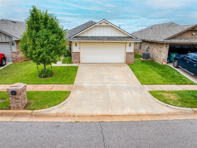 12825 William Penn Blvd, Oklahoma City, OK 73120 - view of front facade with a front lawn, brick siding, concrete driveway, and central AC