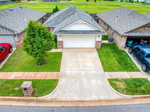 12825 William Penn Blvd, Oklahoma City, OK 73120 - view of front facade with brick siding, driveway, an attached garage, and a front yard