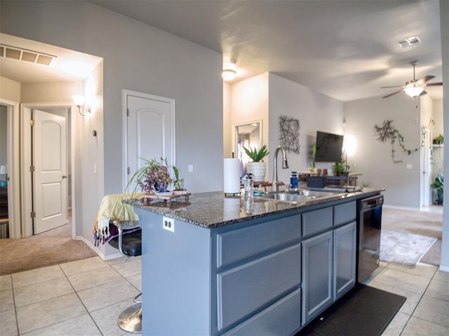 12825 William Penn Blvd, Oklahoma City, OK 73120 - kitchen featuring dishwasher, a sink, light carpet, light tile patterned flooring, and a kitchen island with sink