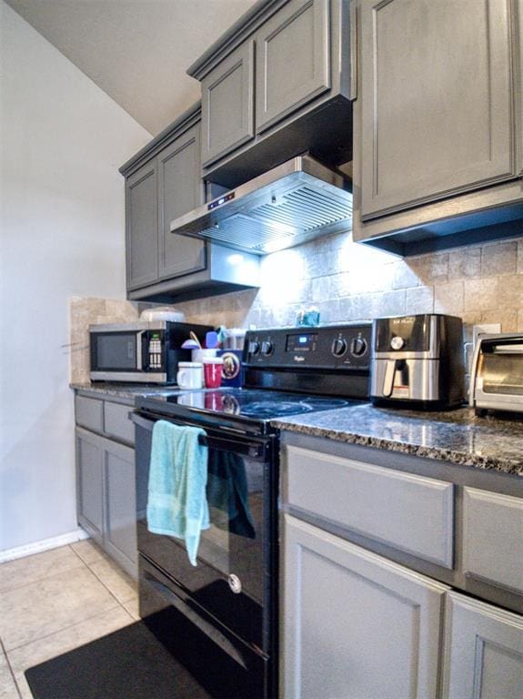 12825 William Penn Blvd, Oklahoma City, OK 73120 - kitchen with black range with electric stovetop, gray cabinets, wall chimney range hood, backsplash, and light tile patterned floors