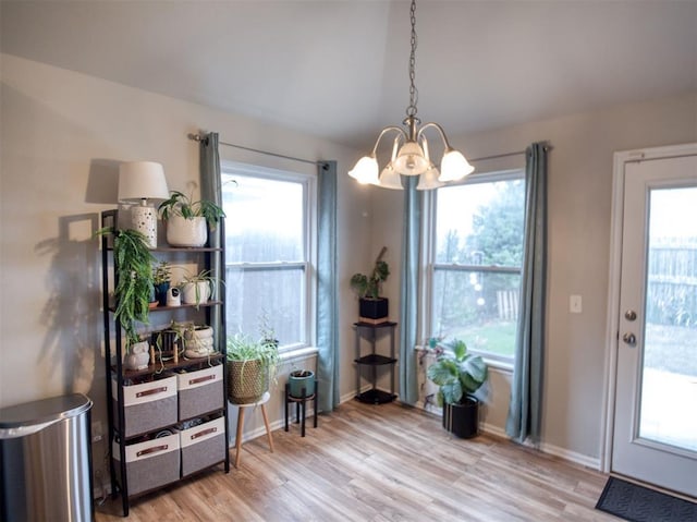12825 William Penn Blvd, Oklahoma City, OK 73120 - dining space featuring a chandelier, light wood-style floors, and plenty of natural light