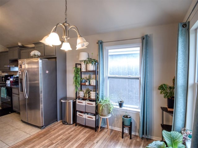12825 William Penn Blvd, Oklahoma City, OK 73120 - kitchen featuring stainless steel fridge with ice dispenser, electric range, a chandelier, light wood finished floors, and pendant lighting