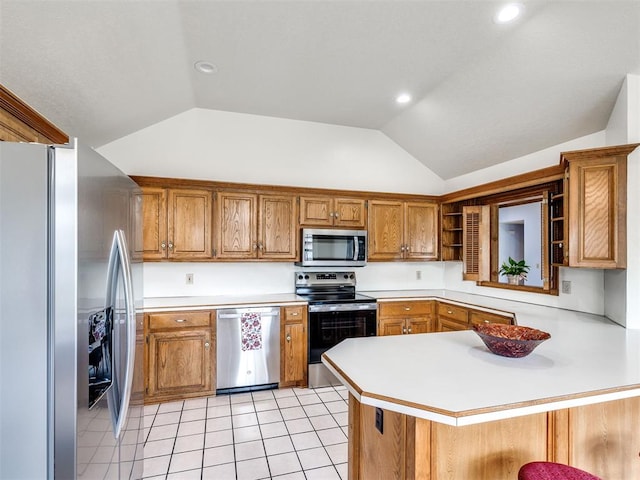 3130 SW 124th St, Oklahoma City, OK 73170 - kitchen featuring stainless steel appliances, lofted ceiling, brown cabinetry, light countertops, and a peninsula